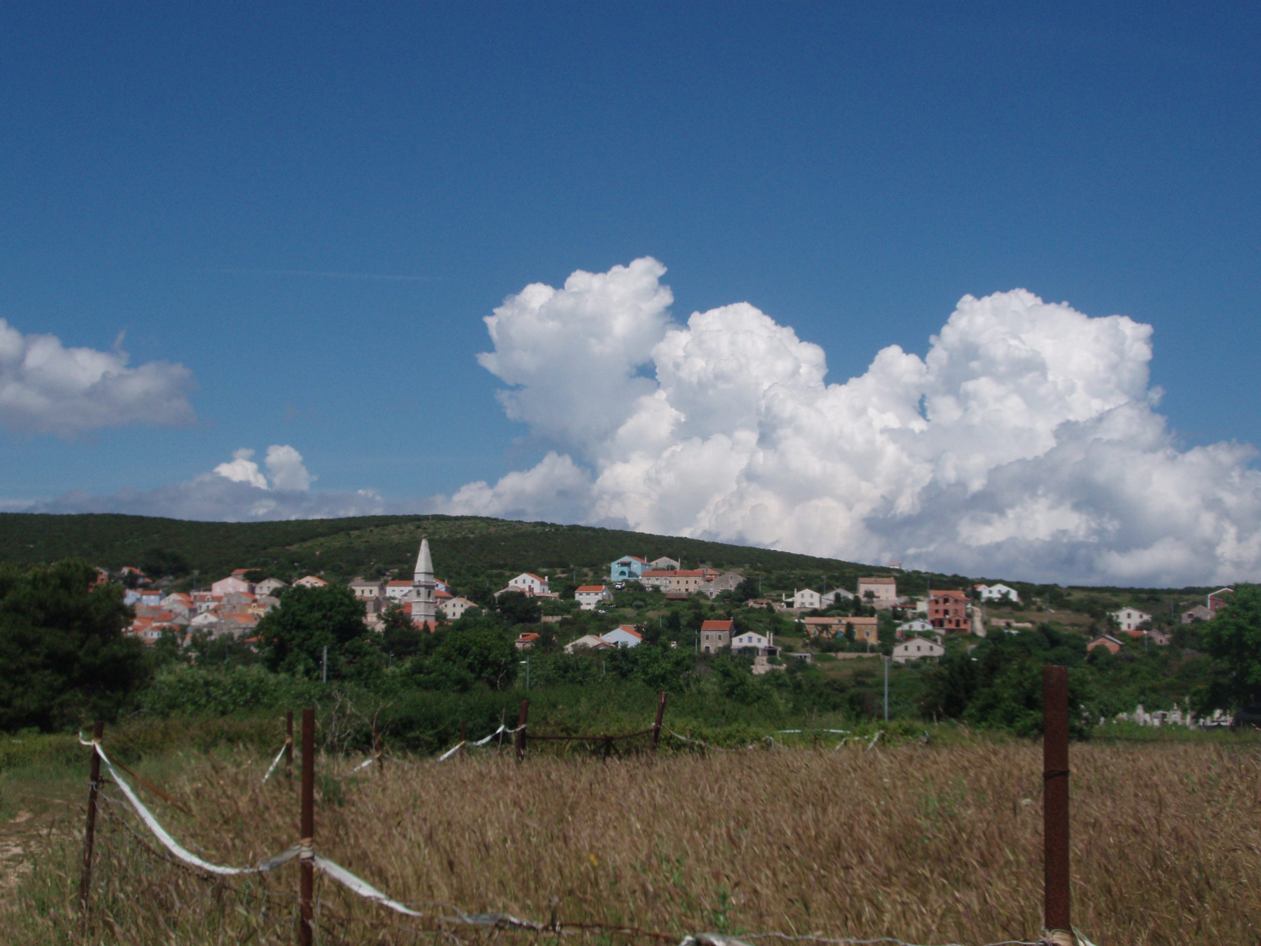 Clouds towering above the only settlement on Unije, the island that boasts a small airport. 